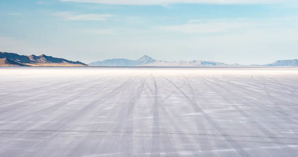 Wide view showing the best time to visit the Bonneville Salt Flats during summer with mountains in the distance 