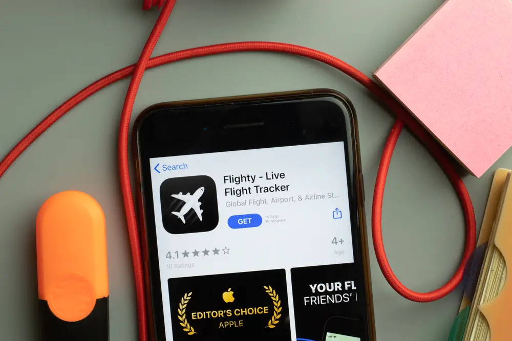 Flighty flight tracking app shown on a smartphone is one of the top trip planning apps to use for flight delays and tracking