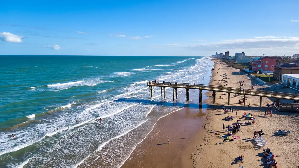 Wooden pier and waves crashing at South Padre Island beach in Texas, one of the best beach destinations in the United States