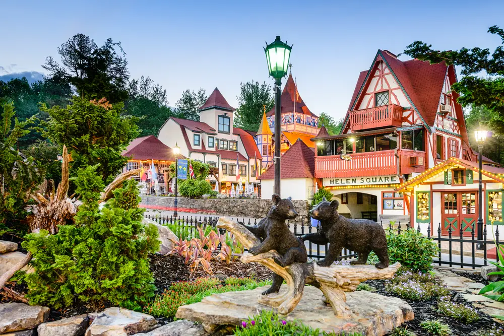 Idyllic town of Helen in Georgia, one of the state's best places to visit, with Bavarian inspiration, seen from a park behind a statue of two bears playing