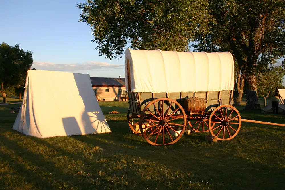 Old covered wagon parked in a field in Wyoming