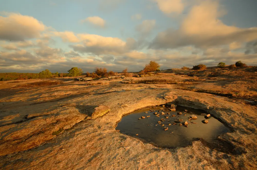Unique puddle of water on a rock face on Arabia Mountain, one of our top picks for must-visit places in Georgia