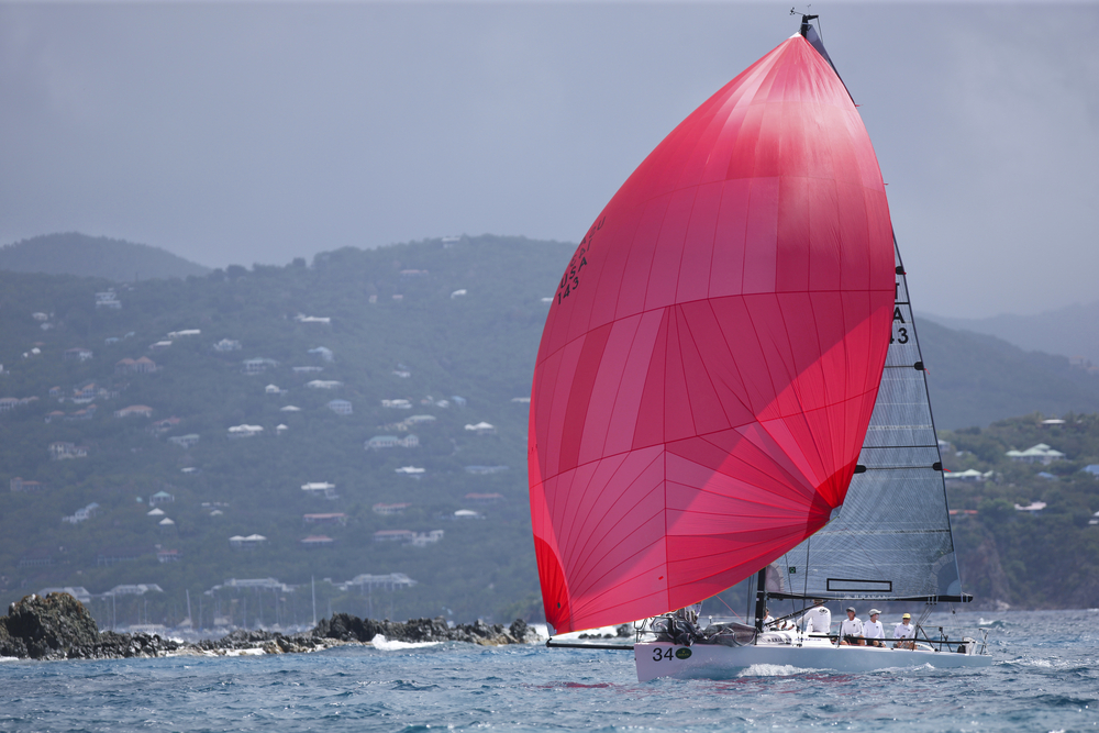 Giant red sail on a boat pictured in March during the best time to go to St. John's Island during the Regatta