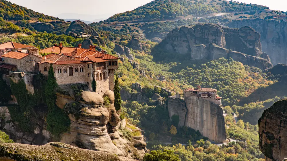 Amazingly breathtaking view of the monastery in Meteora, one of the best areas to stay in Greece, towering over the valley below