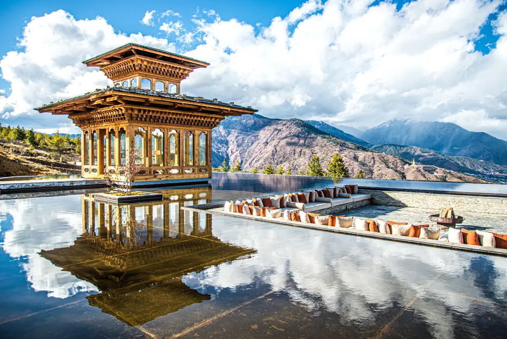 Thimphu resting area by a pool at a temple in Bhutan that overlooks a mountain range