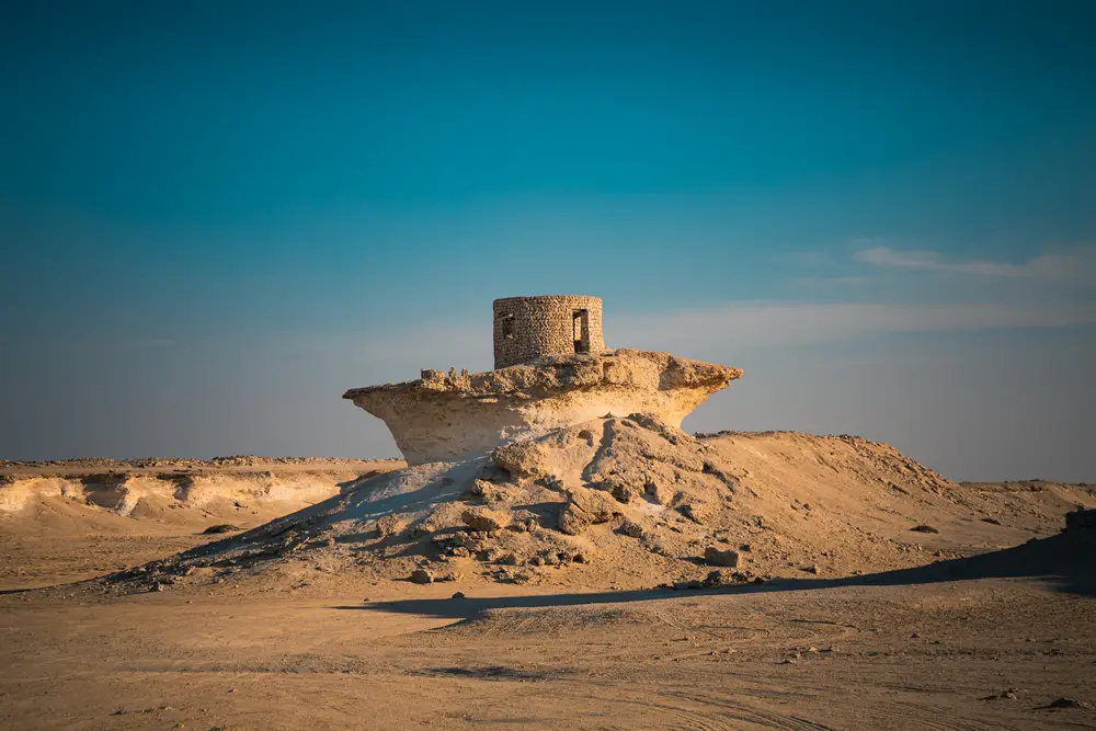Stone fort located in the Mystery Village Zekreet on a hot day during the worst time to visit Qatar from June to August