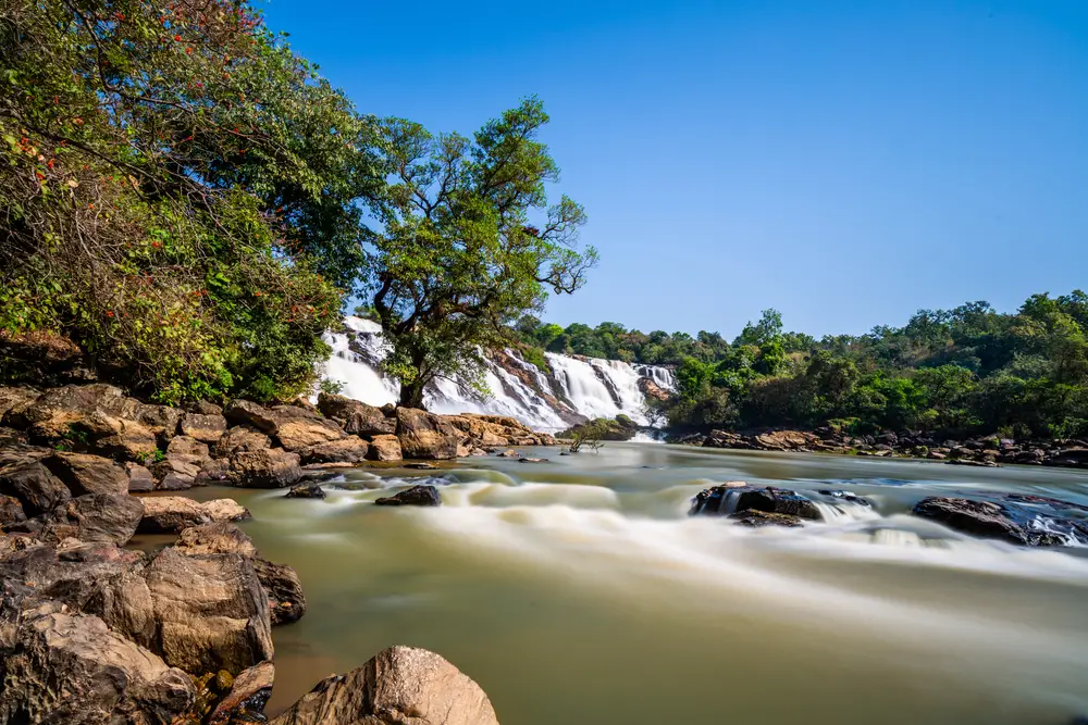Gurara Falls in Niger State shown with time lapse water flowing on a beautiful day during the best time to visit Nigeria