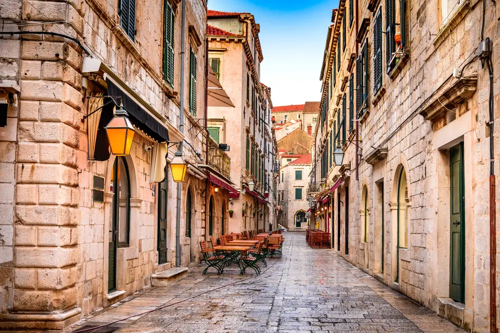 Stone street view on Placa Street with old buildings lining the sides to indicate why you should visit Dubrovnik