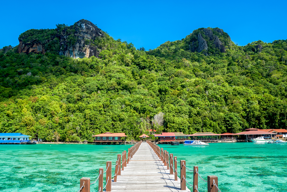 Long wooden jetty leading to Bohey Dulang Island to illustrate that Borneo is safe to visit if you stay in the right place