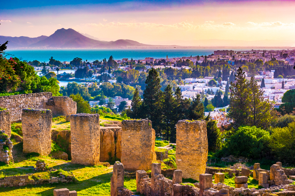 Hill Byrsa ruins of Carthage at dusk with town and Atlas Mountains in the distance during the overall best time to visit Tunisia