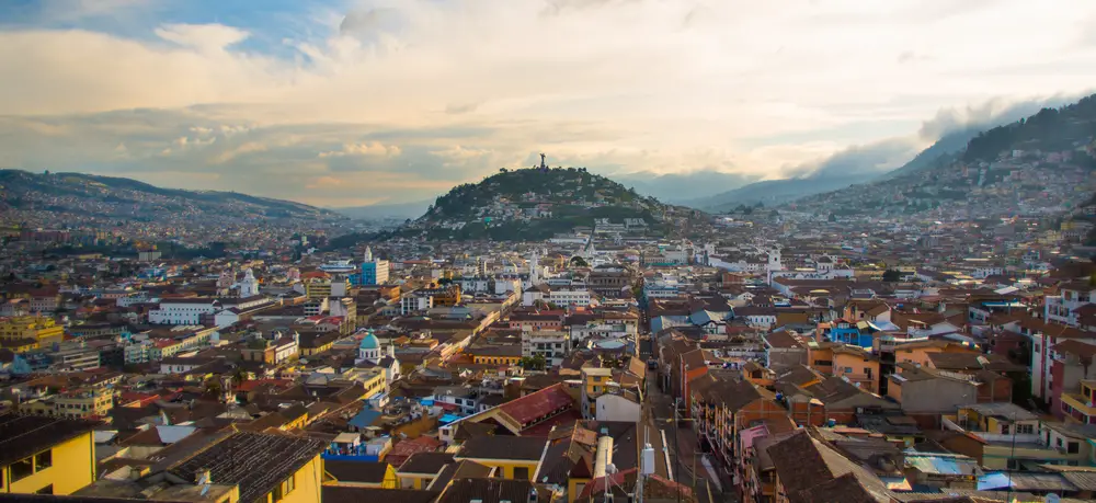 Aerial view of Quito, Ecuador in the historic city center with clouds in the sky at sunrise to show what one of the most dangerous countries in South America is