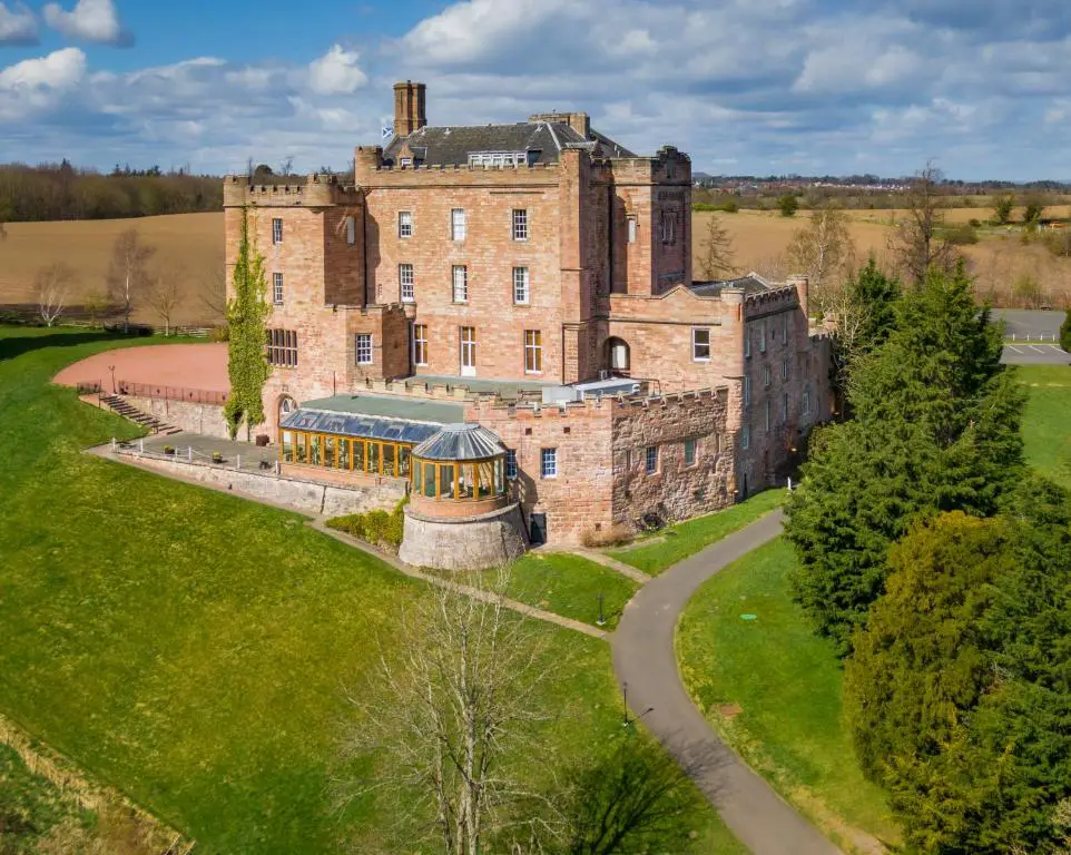 Dalhousie Castle Hotel in Scotland pictured from the outside of its opulent grounds