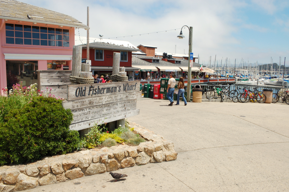 People walking into a restaurant in the Old Fisherman's Wharf in the downtown area of the city, one of the best places to stay on a trip to Monterey