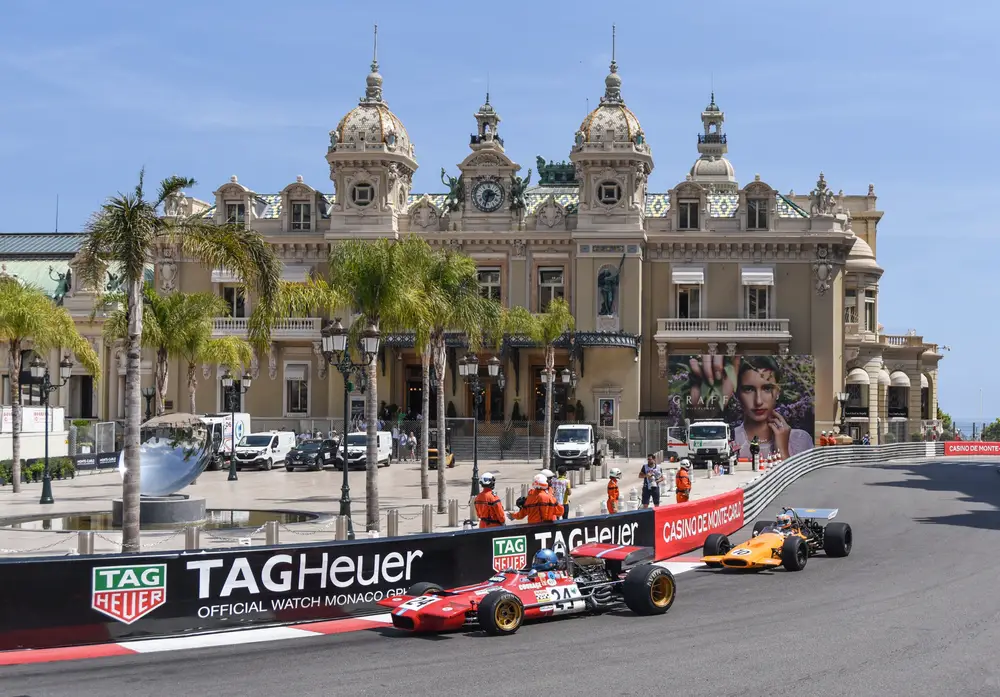 F1 cars fly by the Casino de Monte Carlo during a practice race for a piece titled Where to Stay in Monaco