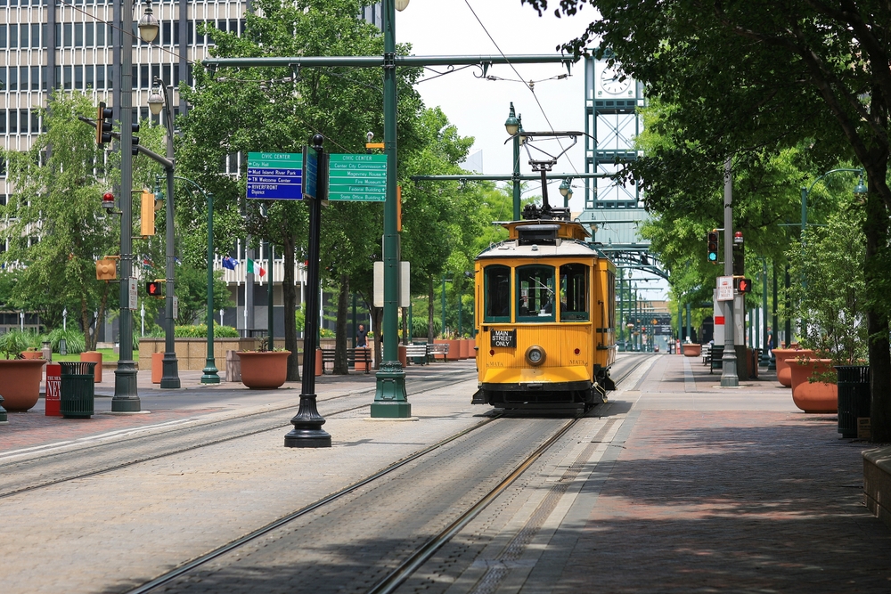 Yellow electric trolley on Main Street in downtown Memphis for a piece on the best parts of the city in which to stay
