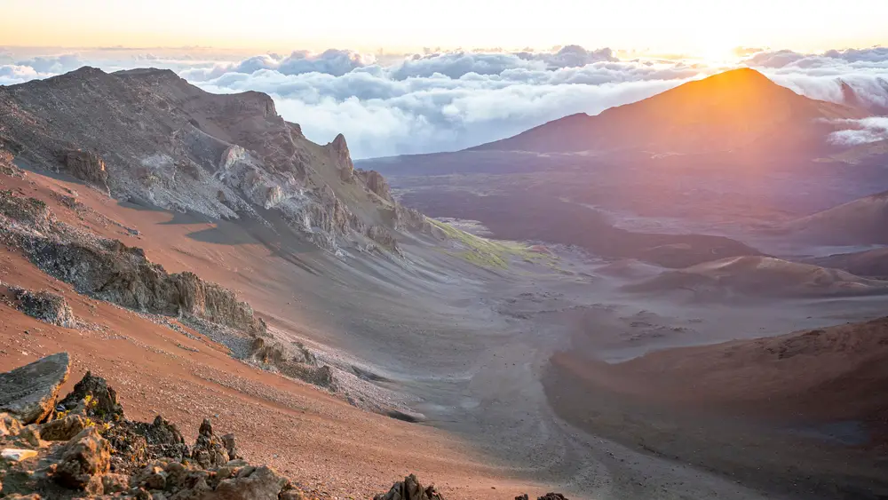 Breathtaking view of Haleakala National Park with the sun rising over the volcano in the background