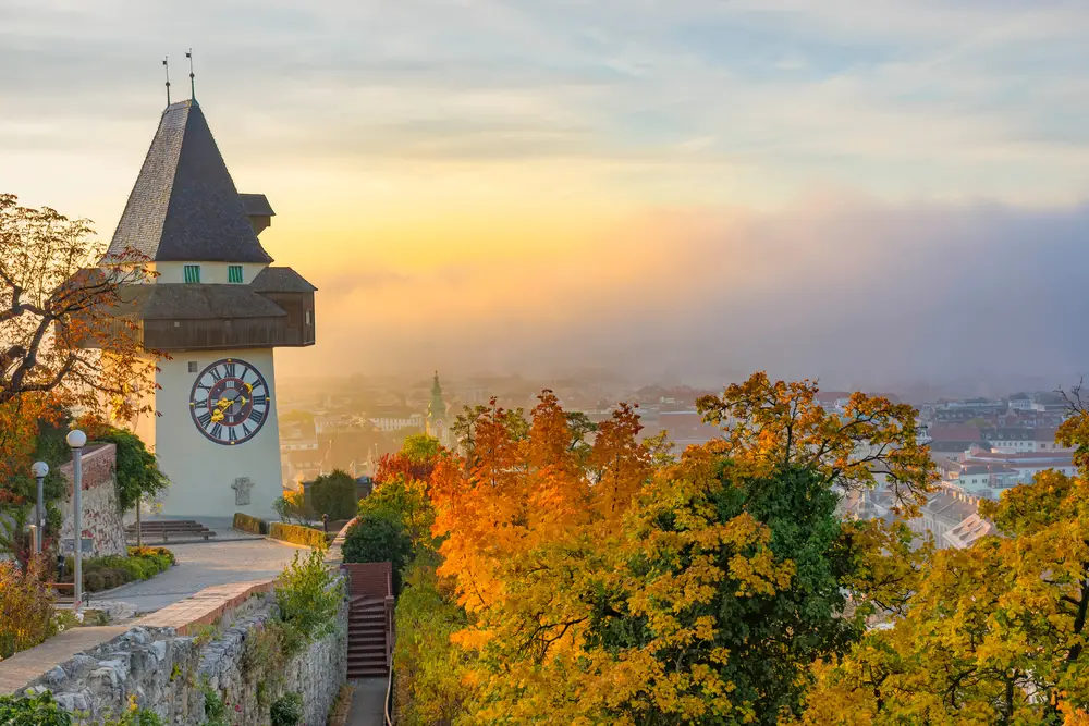 Famous clocktower on Schlossberg Hill in Graz, one of our top picks for the best areas to stay in Austria