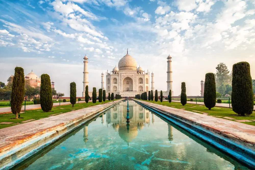 The Taj Mahal in Agra, India with the reflecting pool in the foreground during the afternoon tops the list of the best bucket list travel ideas 