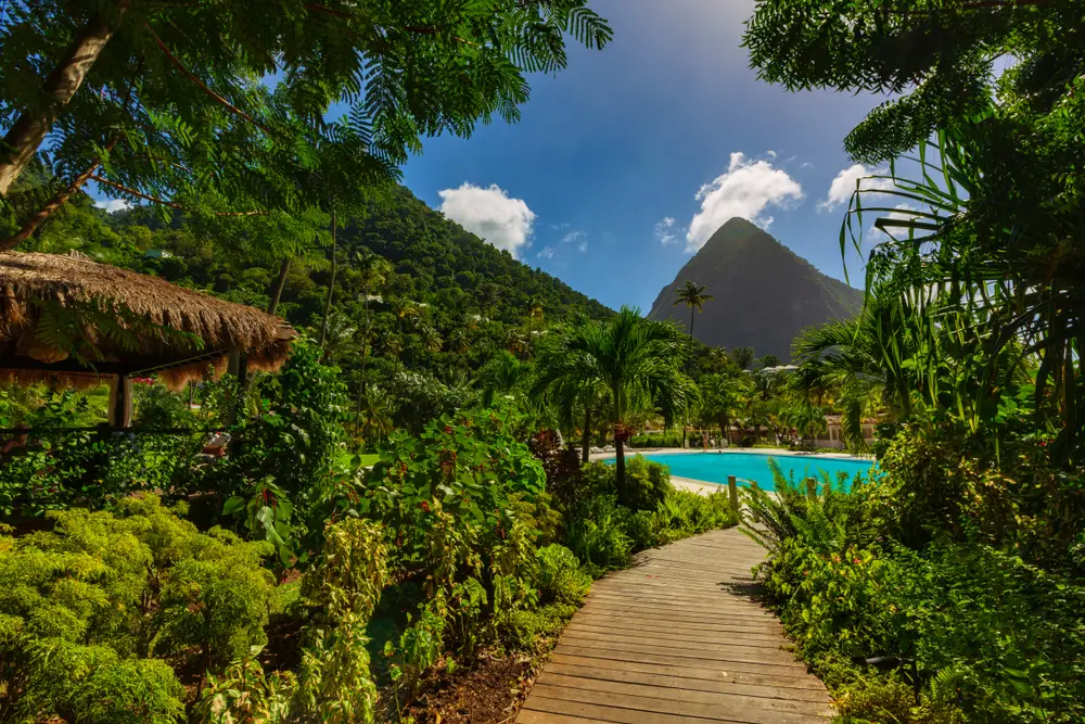 La Soffriere Bay in St. Lucia is one of the best honeymoon spots in the world, shown with wooden walkway leading through the greenery to the beach