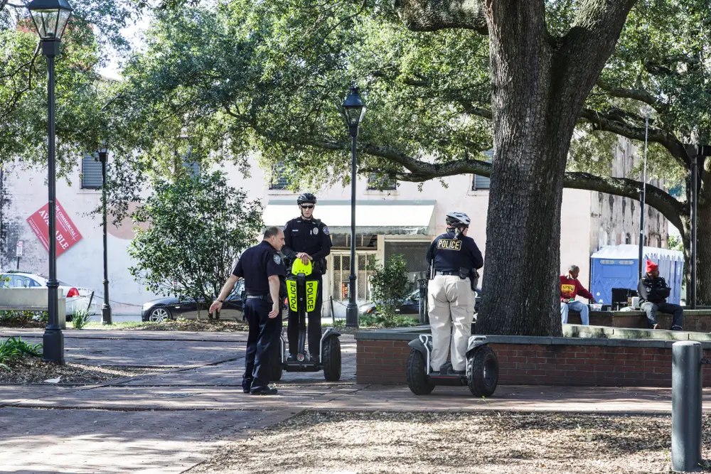 Photo for a guide titled Is Savannah Safe to Visit featuring three police officers on Segways patrolling the area
