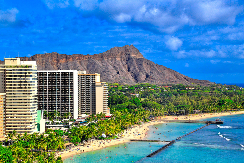 Aerial view showing Diamond Head State Monument crater on Waikiki Beach in the foreground to highlight Oahu as one of the best tourist spots in the world