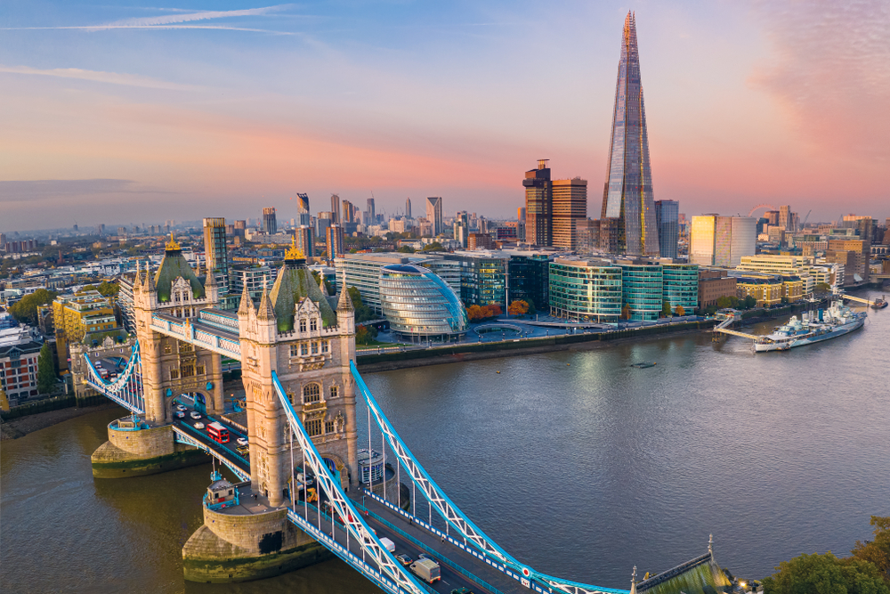 The Tower Bridge in London shown with a view of the cityscape and skyline at dusk for a list of the top places for tourists to visit around the world