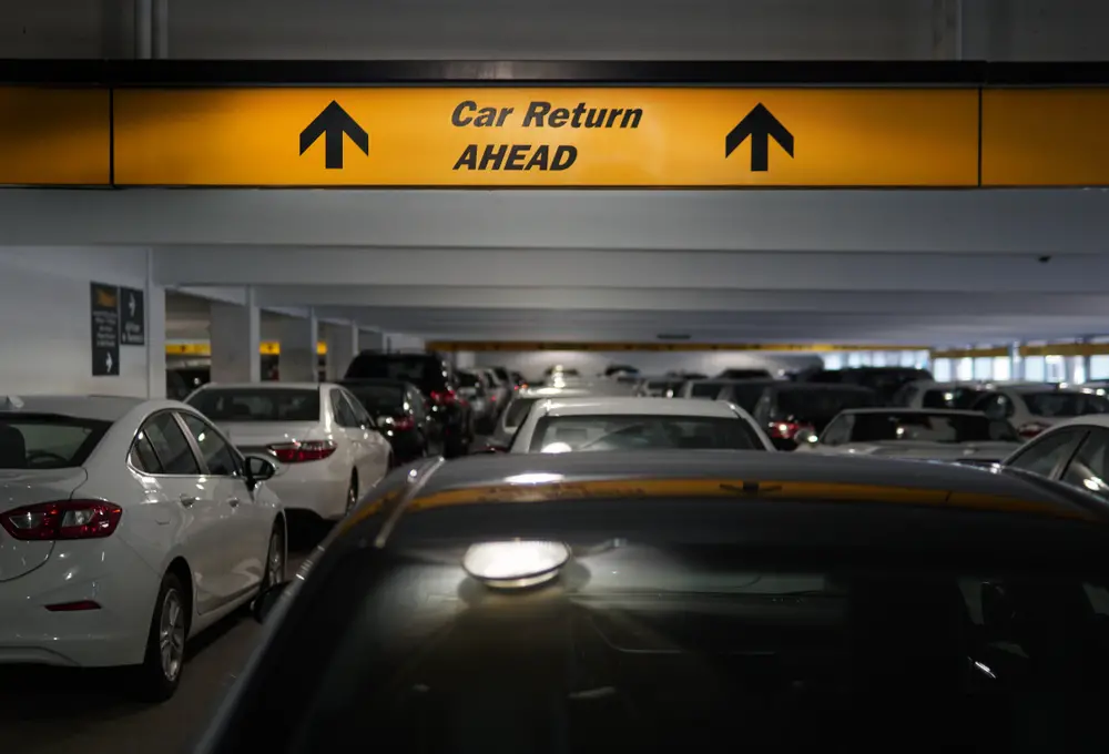 Rental car return lane at an airport shows the concept of a one-way rental and asking can you take rental cars out of state?