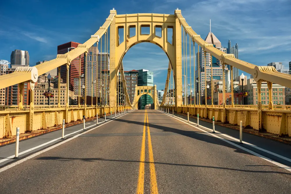 Traffic and people crossing the Allegheny River across the Roberto Clemente Bridge for a section on why you should visit Pittsburgh