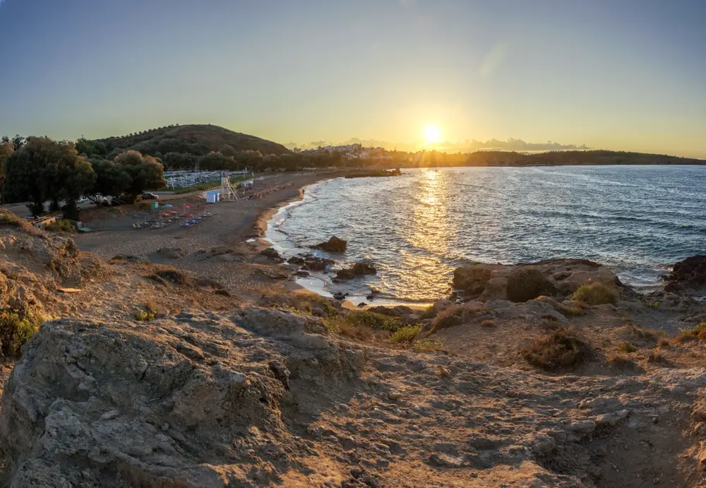 Sun setting over the rocky coast of Chrissi Akti near Chania, one of the best areas to stay in Paros
