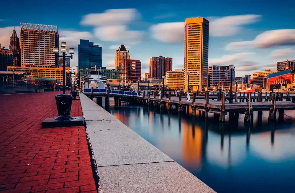 Long exposure image of downtown Baltimore, MD skyline at the Inner Harbor in the late afternoon to show one of the cheapest places to travel to in the United States