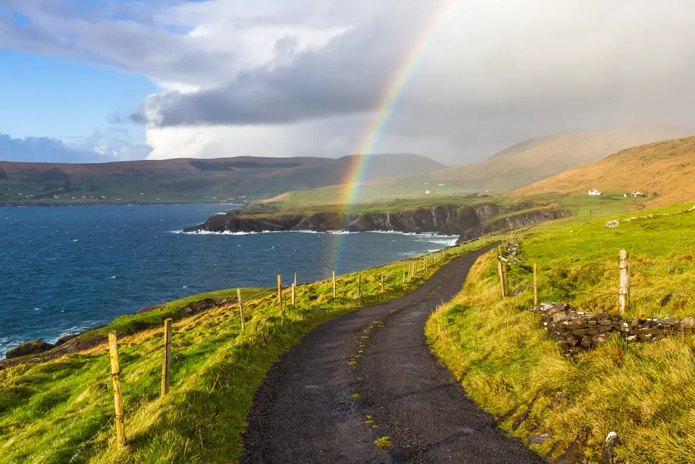As an image for a piece on the average Irish trip cost, a rainbow pictured going over the road on a typical rainy day