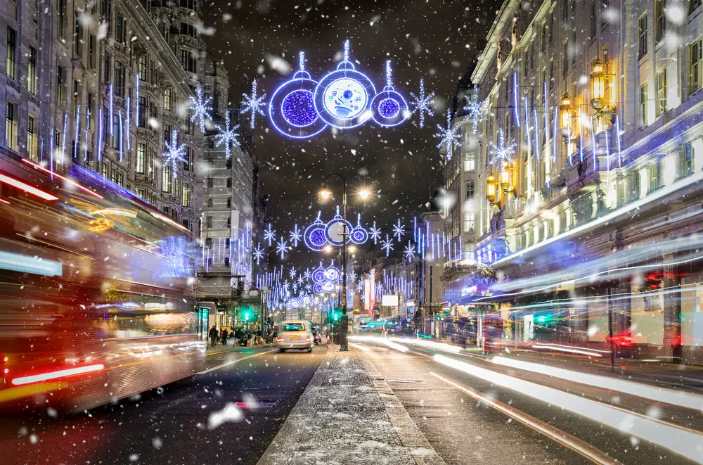 Blurry lights in a long exposure image at Christmas time in London for a guide titled Cost to Visit England