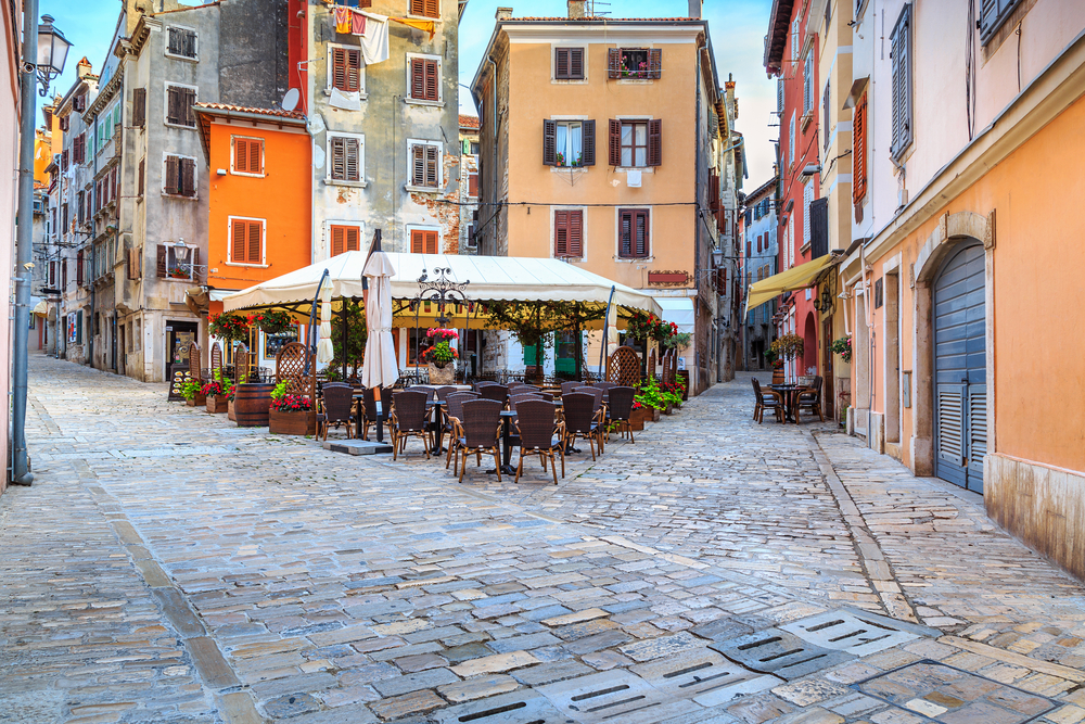 Neat paved street of a cafe in Croatia pictured for a guide to the average cost of a trip to the country