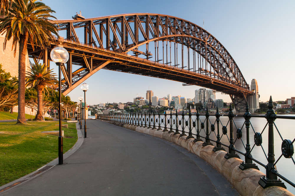 Sydney Harbor Bridge in Circular Quay, one of the best parts of town to stay in when visiting Sydney, pictured on a nice day with nobody on the path