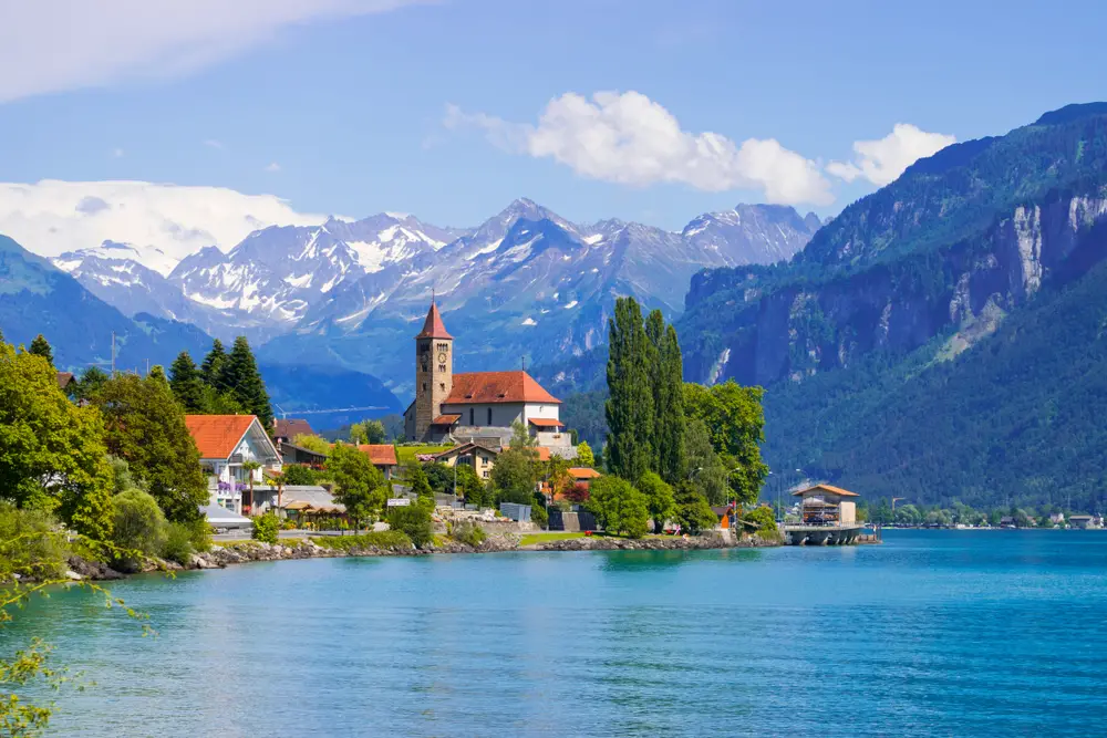 Lake Brienz and the town seen with the Swiss Alps in the background for a list of the best trips for groups of friends to take