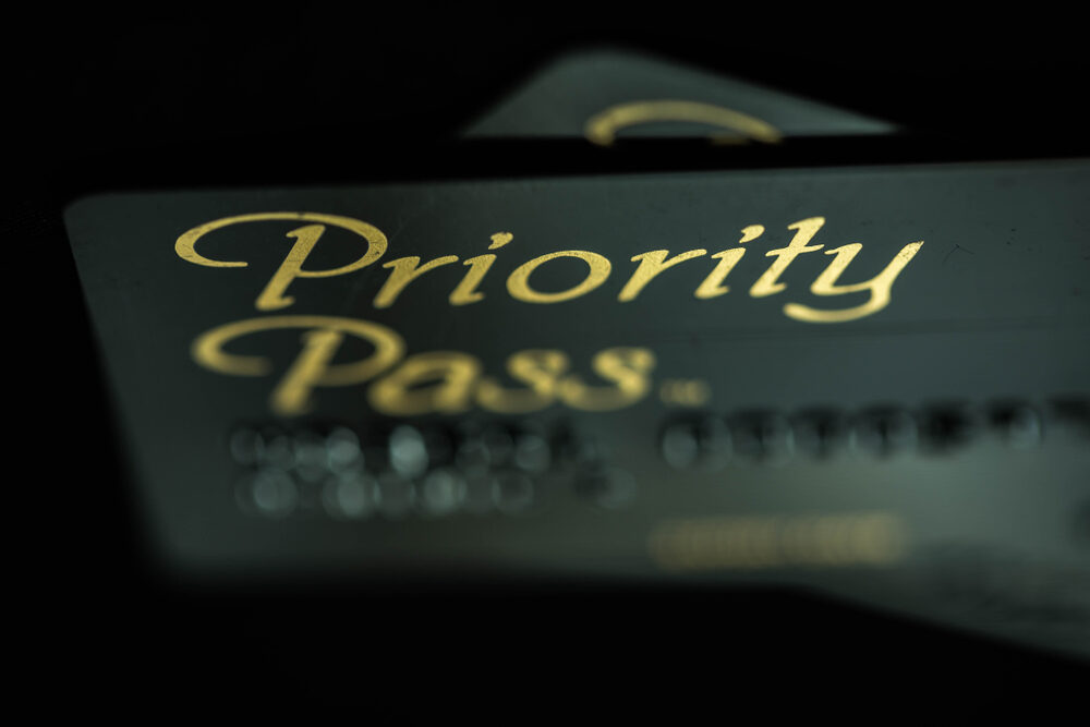 Close-up blurry image of a Priority Pass membership card for an article asking Are Priority Pass lounges usually crowded?