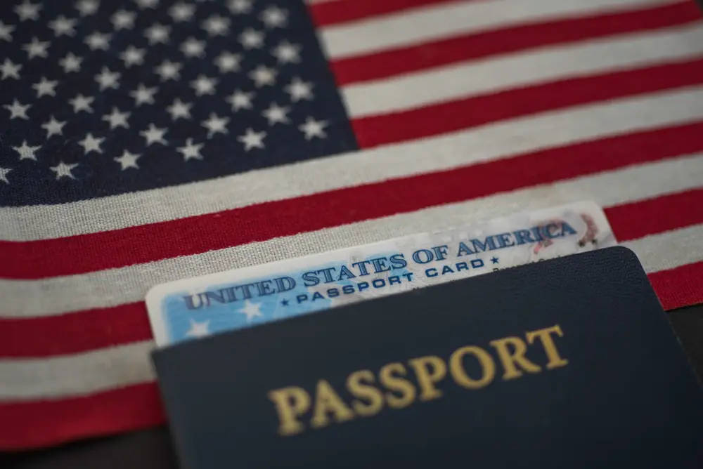 American flag behind a passport book and passport card for a section explaining what passport travel document numbers look like