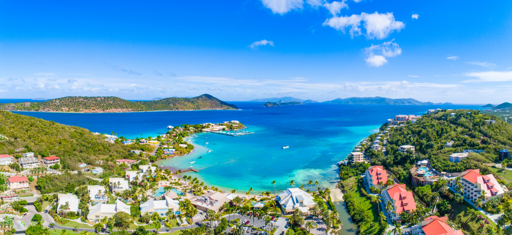 Aerial view of St. Thomas with homes and greenery around the bright blue water for a list of top places to travel without a passport