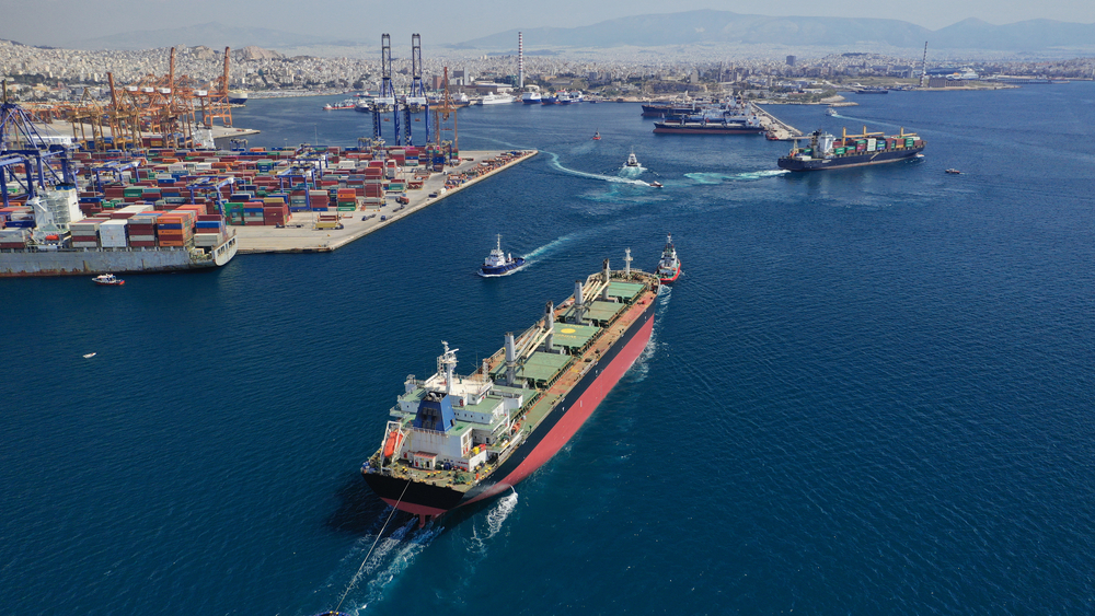 Aerial view of a port where large ships can be seen loaded with tons of cargo. 