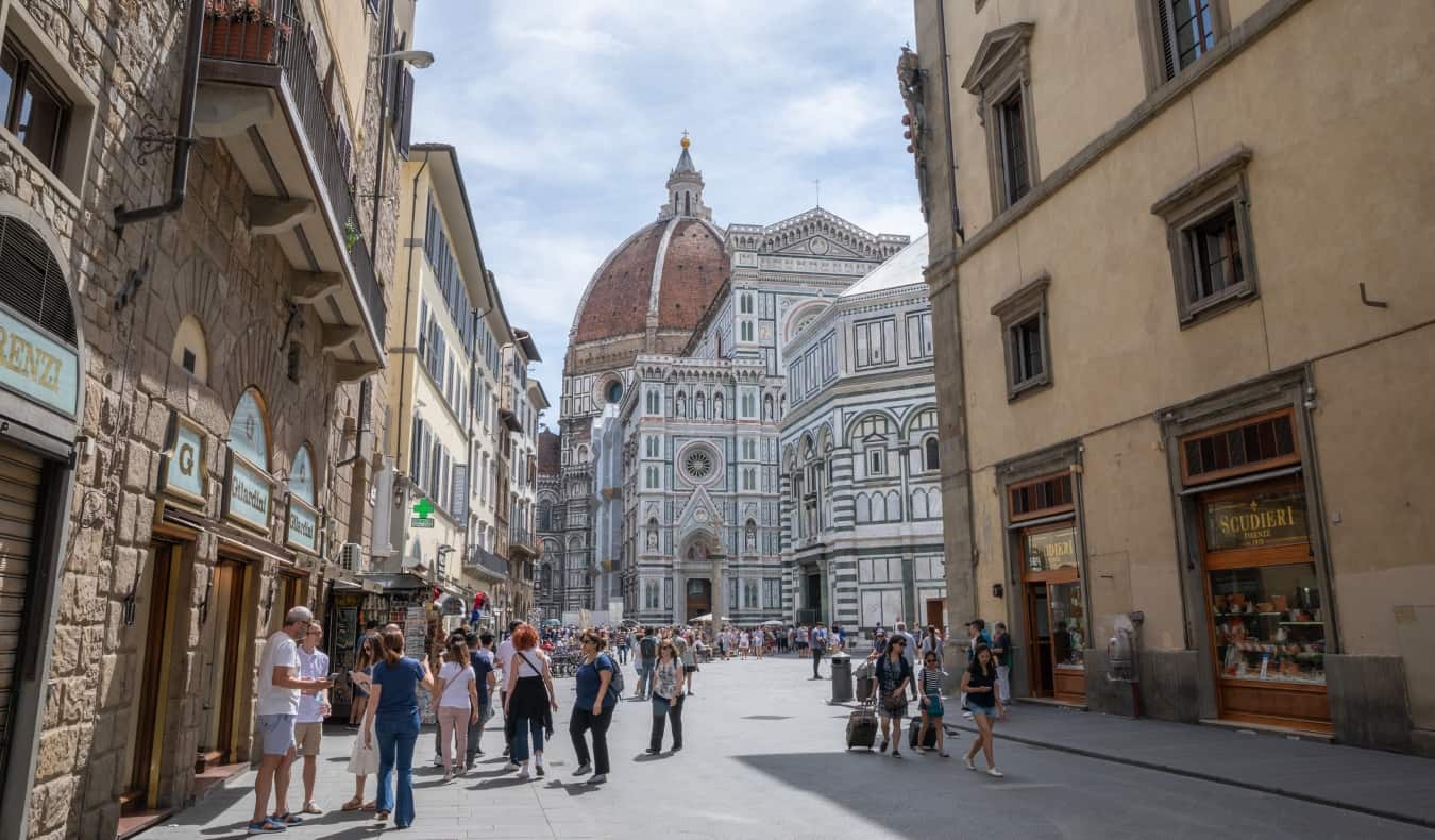 Άνθρωποι που μαζεύονται στο δρόμο με τον εμβληματικό καθεδρικό ναό Duomo στο βάθος στη Φλωρεντία, Ιταλία